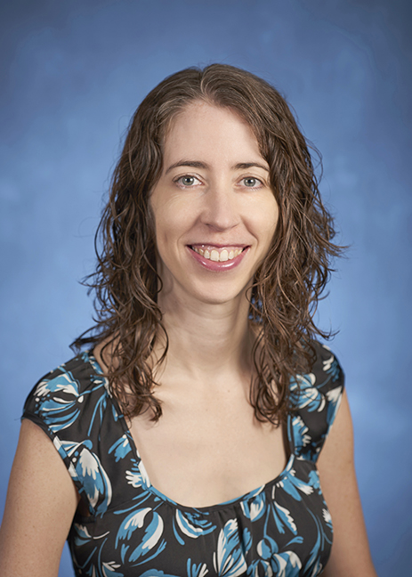 Headshot of Erica Frankenberg with long brown hair and multi-colored blouse.