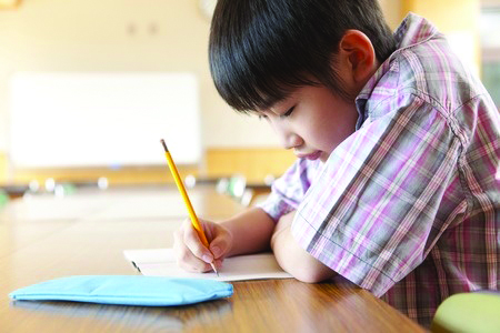 Young Asian boy studying.