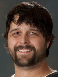 Headshot of David Ramey with long dark brown hair and beard.