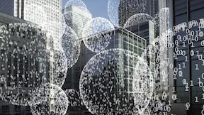 Spheres of 0s and 1s in front of a city landscape.