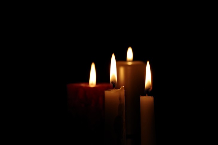 Candles burning in the dark.