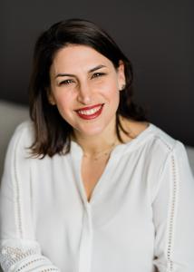 Margolis with long dark hear and white blouse