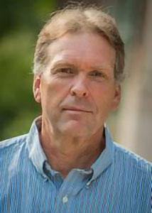 Headshot of Leif Jensen with light colored hair wearing a blue dress shirt.