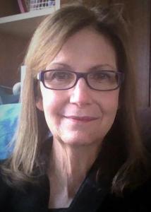 Headshot of Melissa Hardy with long, brown hair wearing glasses and black top.