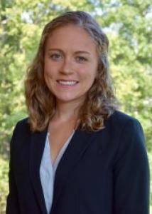 Pakhtigian with long wavy blond hair and blue blazer