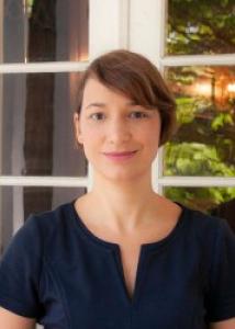 Pessin with short brown hair and blue top