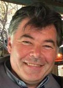 Headshot of Stephen Matthews outside with grey hair.
