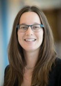 Headshot of Katherine Zipp with long brown hair, glasses, and black top.